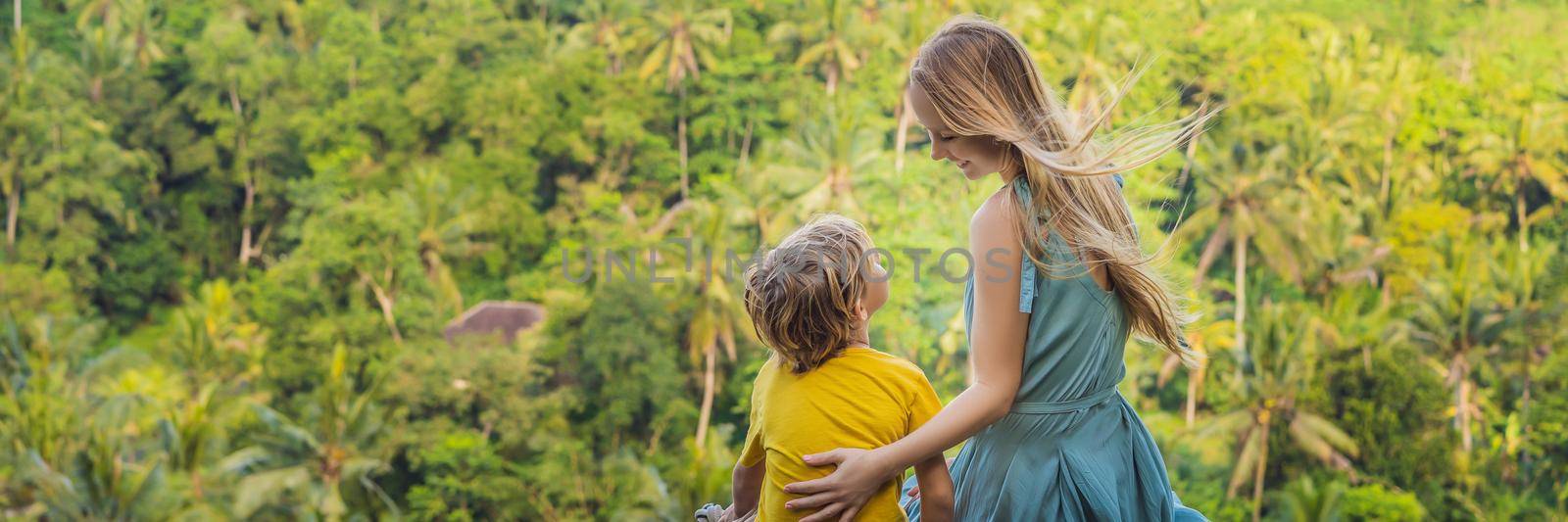 Mom and son tourists on a stone over the jungle. Traveling with kids concept. What to do with children. Child friendly place. BANNER, LONG FORMAT