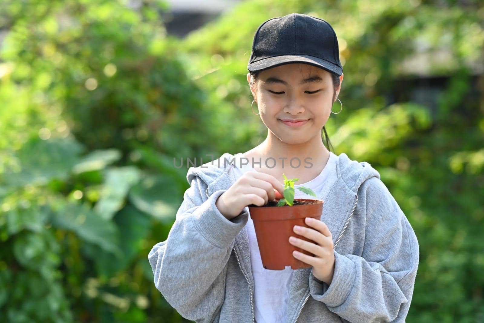 Asian Child hands holding potted plant. Concept of saving the world, Ecology, Earth day.