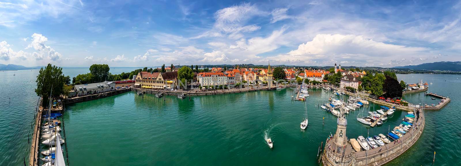Lindau, Germany - July.21 2019: Amazing panorama of Harbor on Lake Constance with a statue of a lion at the entrance in Lindau, Bavaria, Germany. by EdVal
