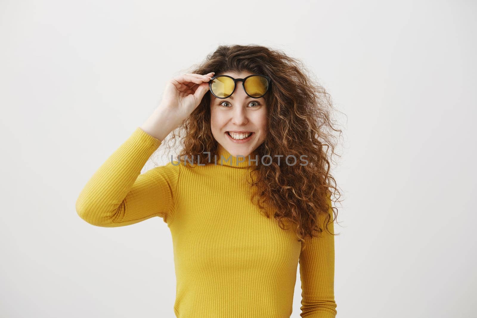 Portrait excited surprise young woman standing isolated over white background. Looking camera