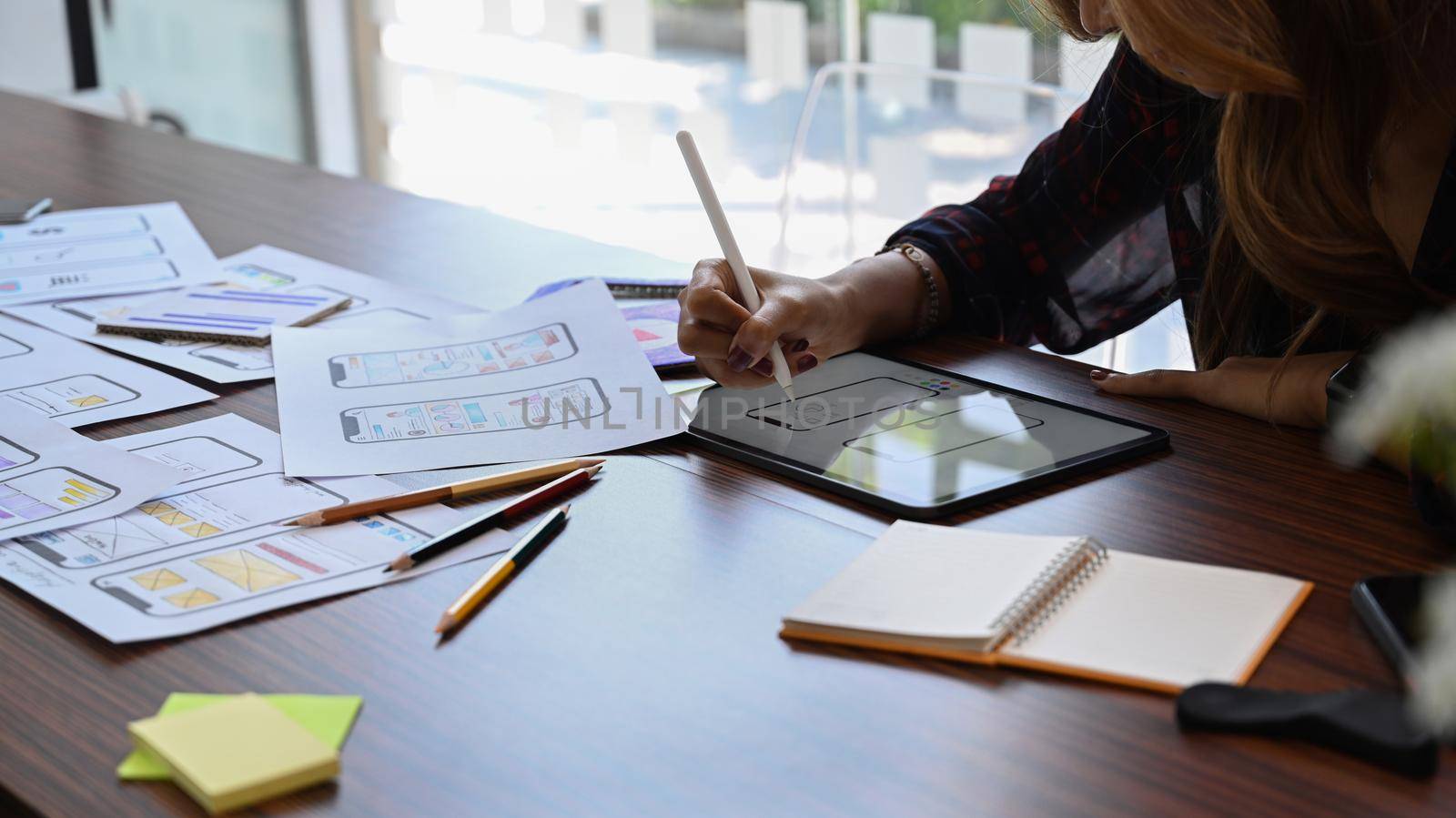 Web designer sketch planning application process development prototype wireframe for web mobile phone.