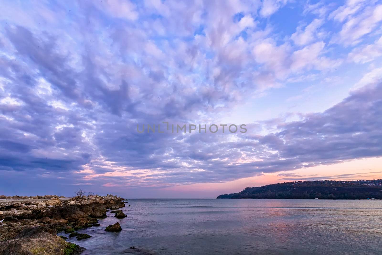 idyllic view with stunning clouds over the sea bay and pier 