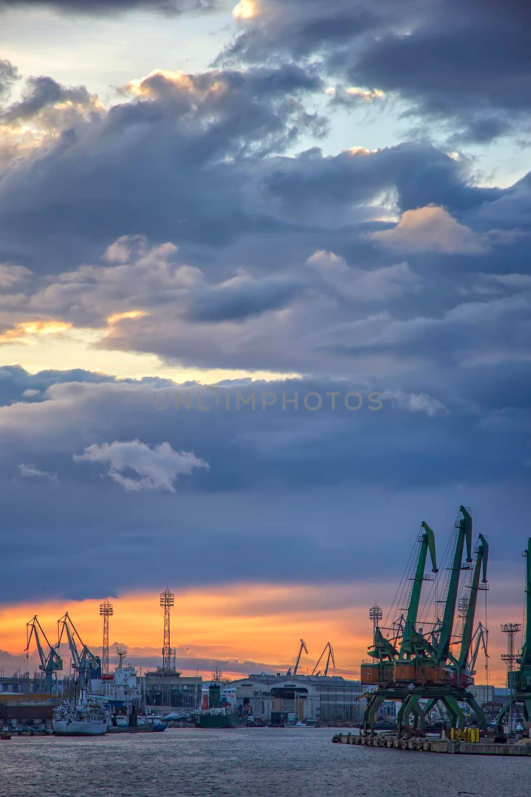 In the evening, the part of port with cranes.Ready to load containers from cargo ships.