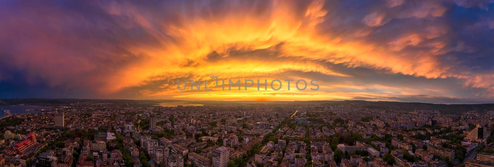 Amazing colorful clouds over the city. Aerial panorama from a drone. Varna, Bulgaria