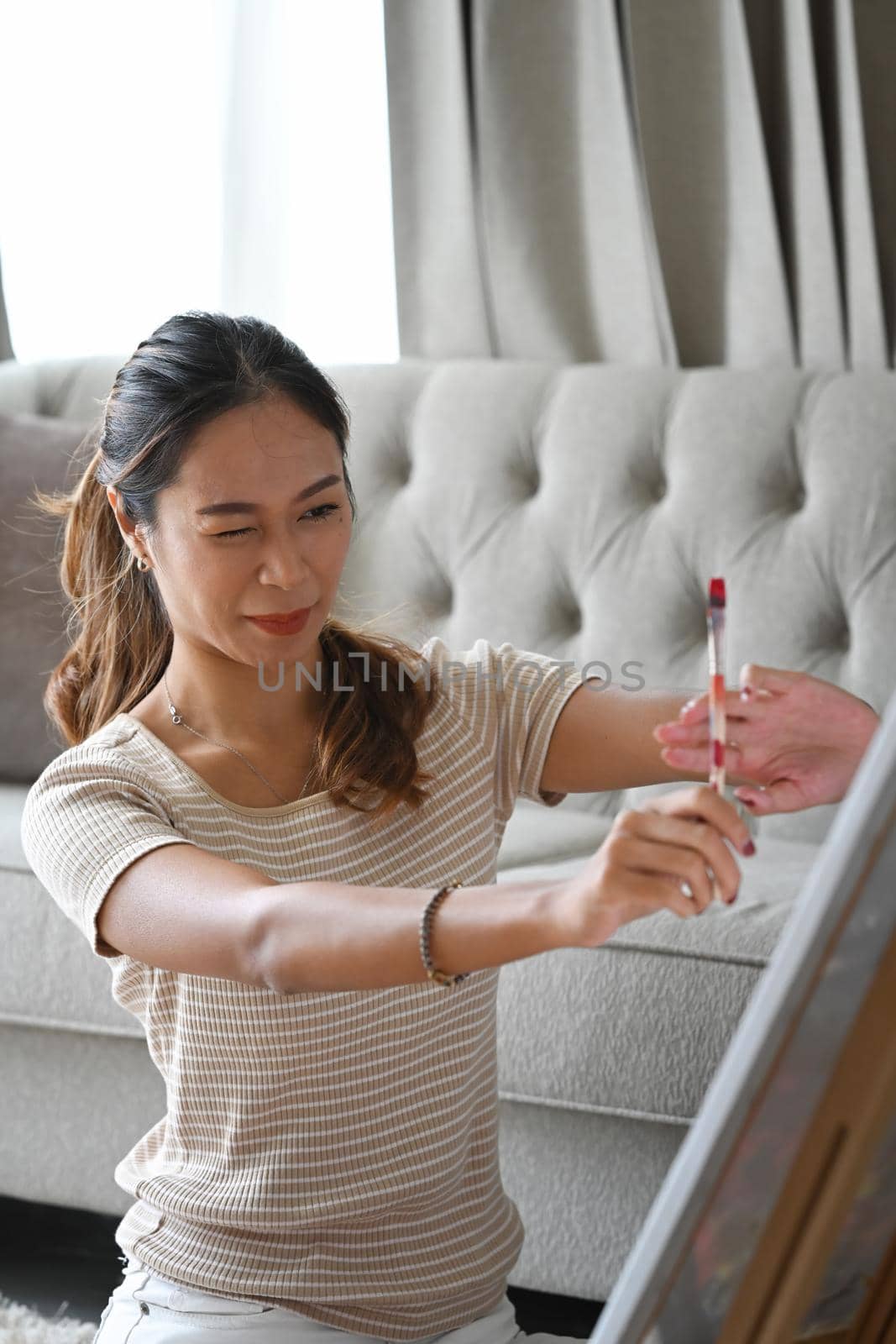 Pretty female artist creating art picture at home. Hobby and leisure concept.