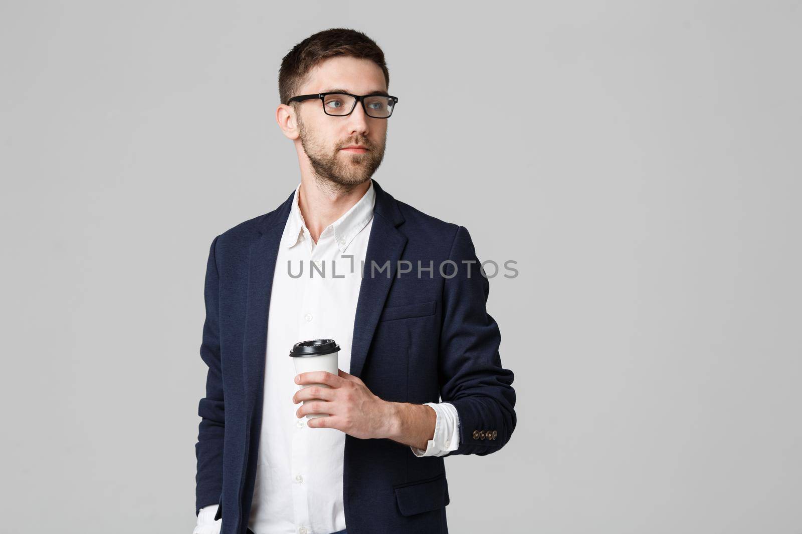 Portrait of a handsome businessman in eyeglasses with a cup of coffee. by Benzoix