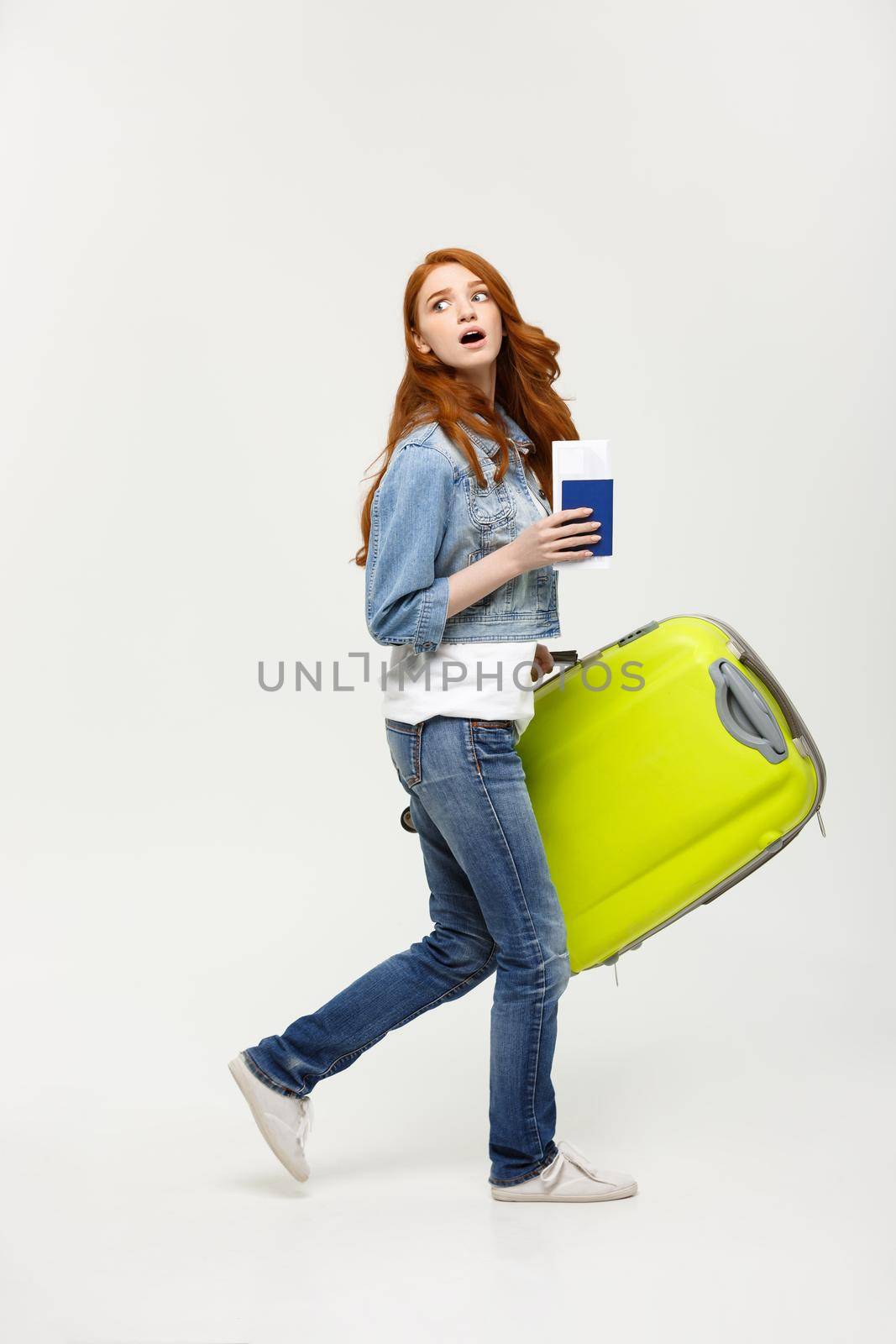 Travel Concept: young caucasian women holding green suitcase between go to the airport
