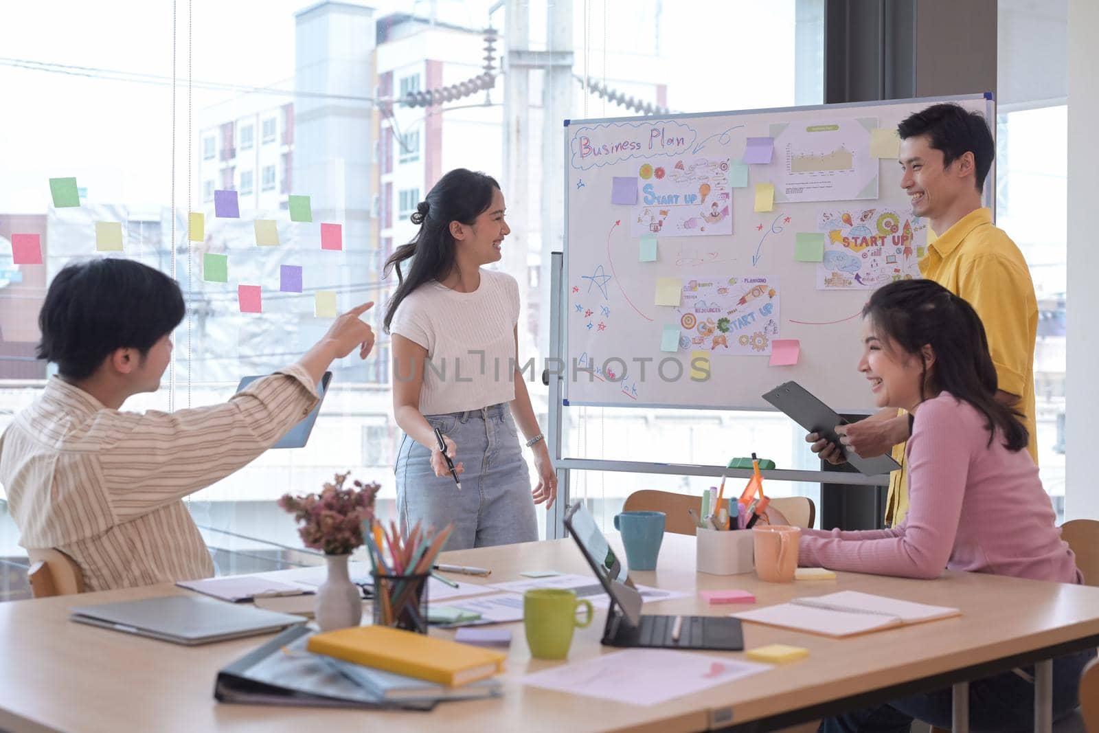 Group of young businesspeople brainstorming and discussing ideas for new startup project together at creative office. by prathanchorruangsak