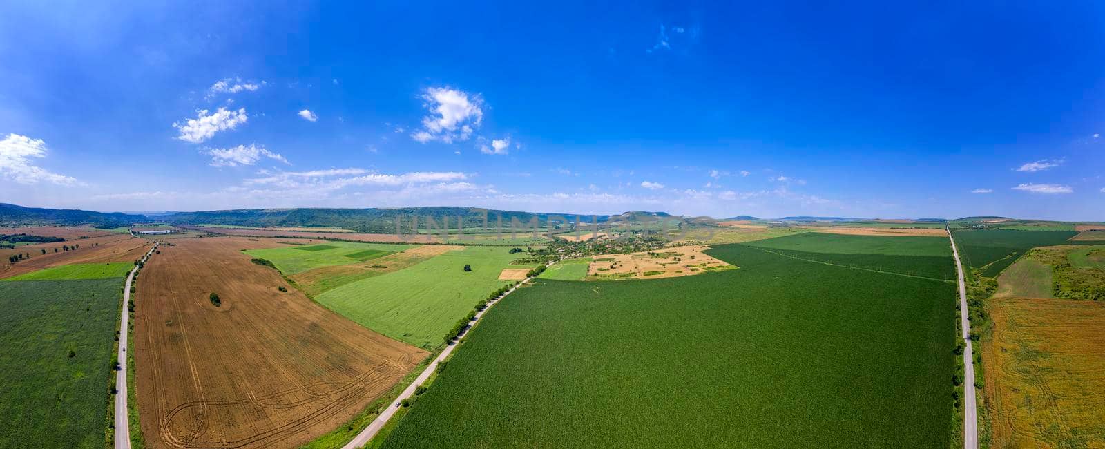 vast aerial panorama view from drone to the countryside roads and fields by EdVal
