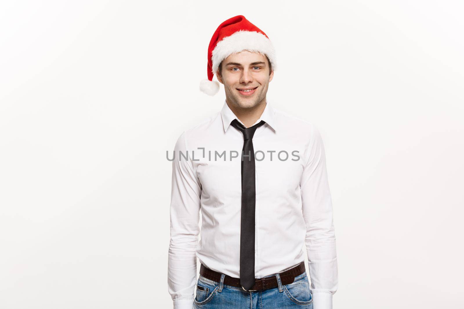 Christmas Concept - Handsome happy Business man wear santa hat posing on white isolated background.