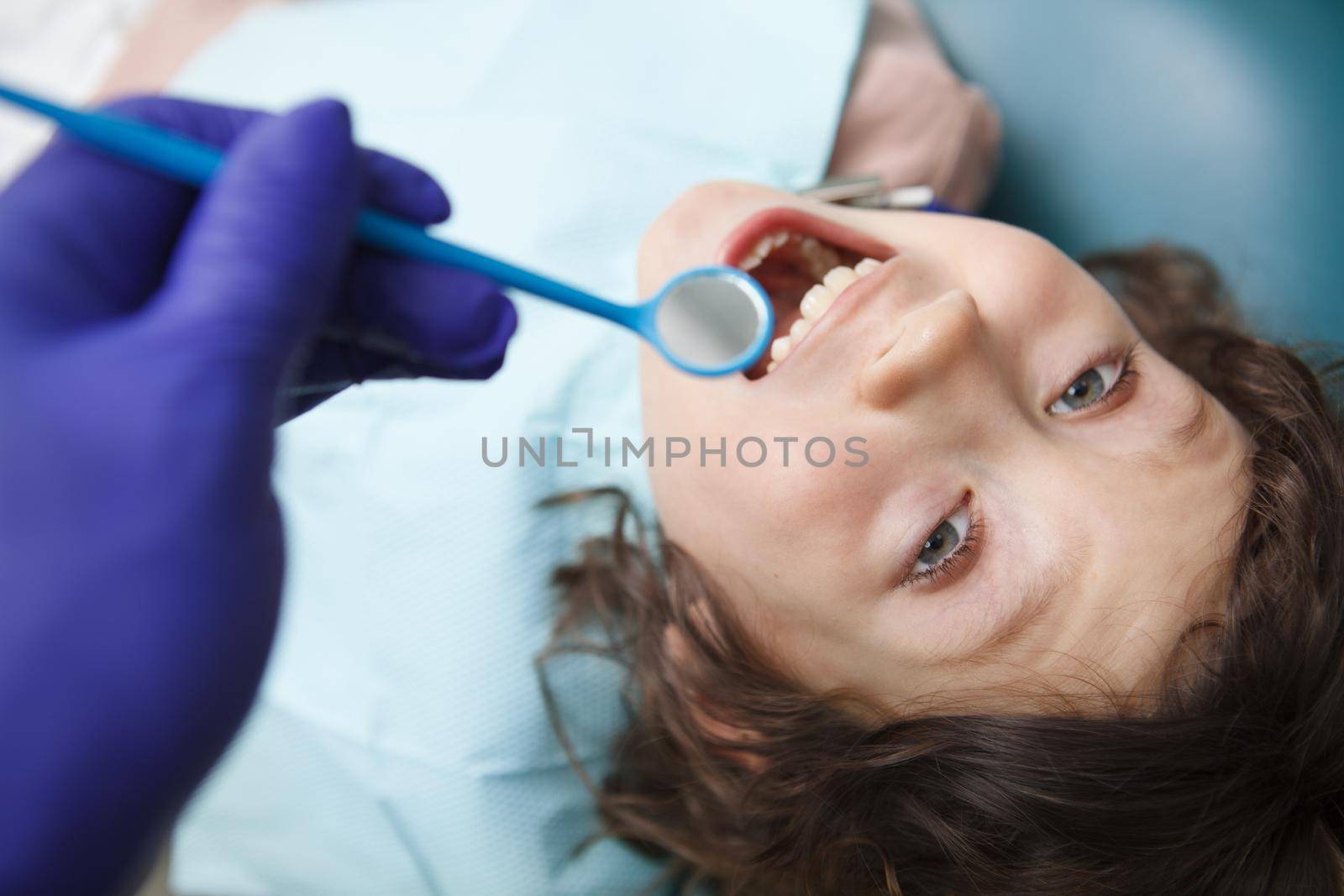 Young boy at dentists office by MAD_Production