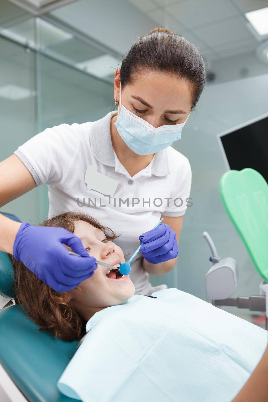 Young boy getting dental treatment by MAD_Production