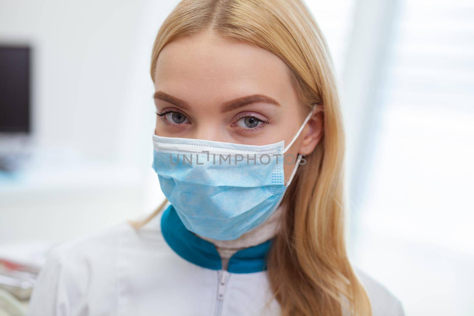 Female dentist working at her dental clinic by MAD_Production
