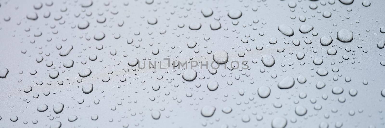 Water drops on glass, gray rainy background, close-up. Sadness and loneliness. Cleanliness and freshness. Design element