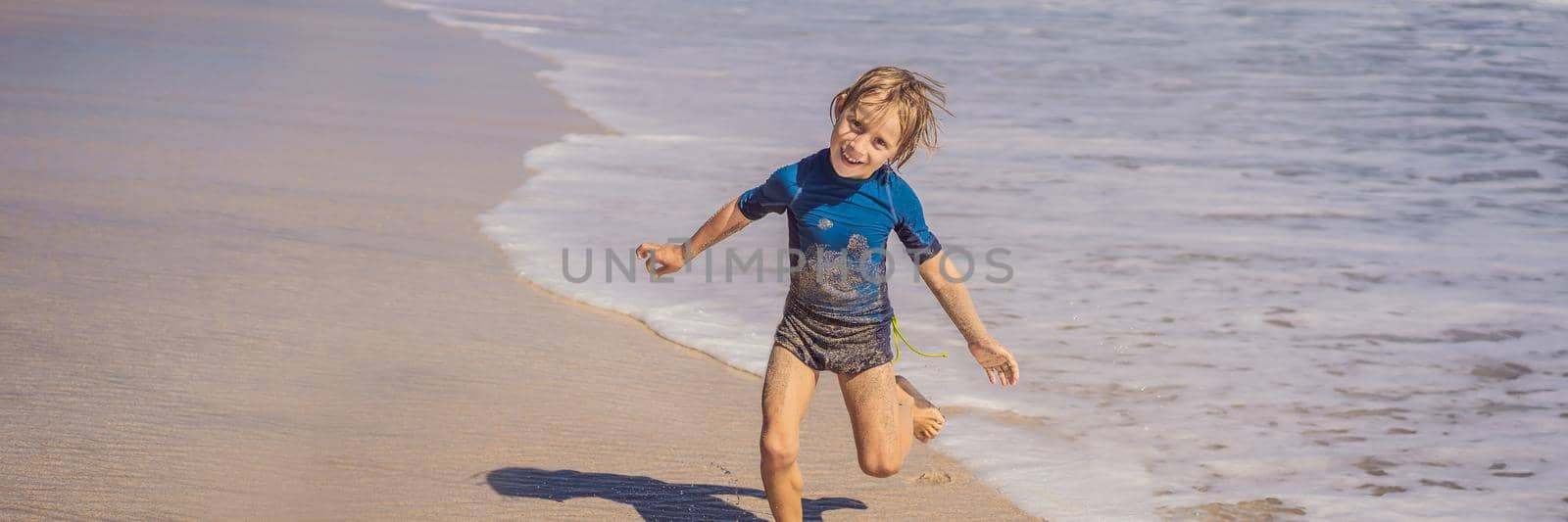 Cute little boy having fun on tropical beach during summer vacation. BANNER, LONG FORMAT