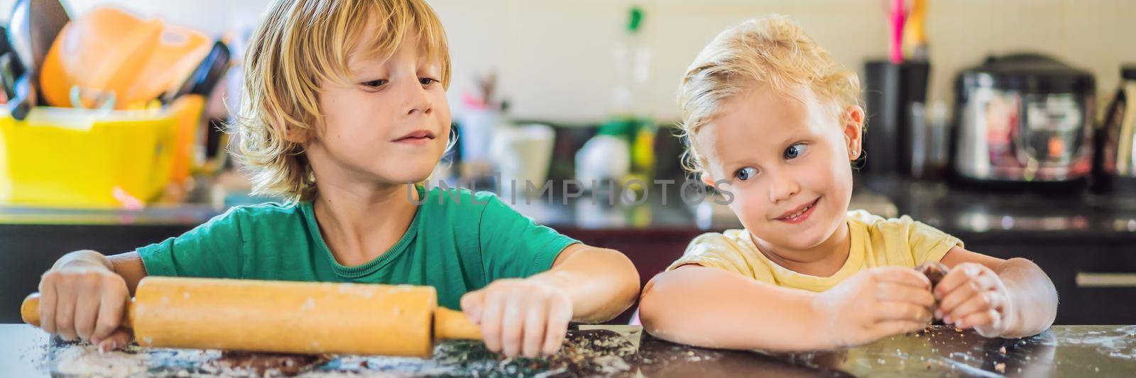 Two children a boy and a girl make cookies from dough BANNER, LONG FORMAT by galitskaya