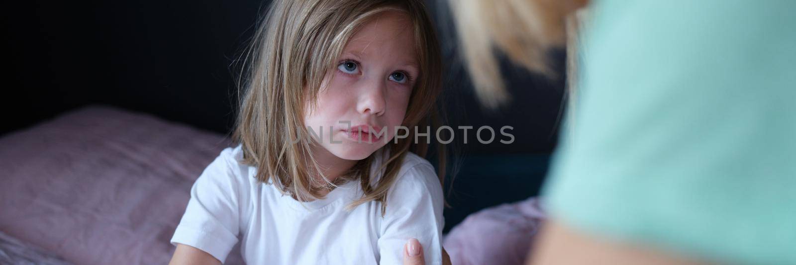 Mom calms a little scared girl on the bed, close-up, Children's nightmare, child's emotional health, insomnia anxiety