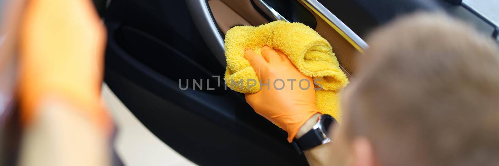 Man wipes the interior of the car with a towel by kuprevich