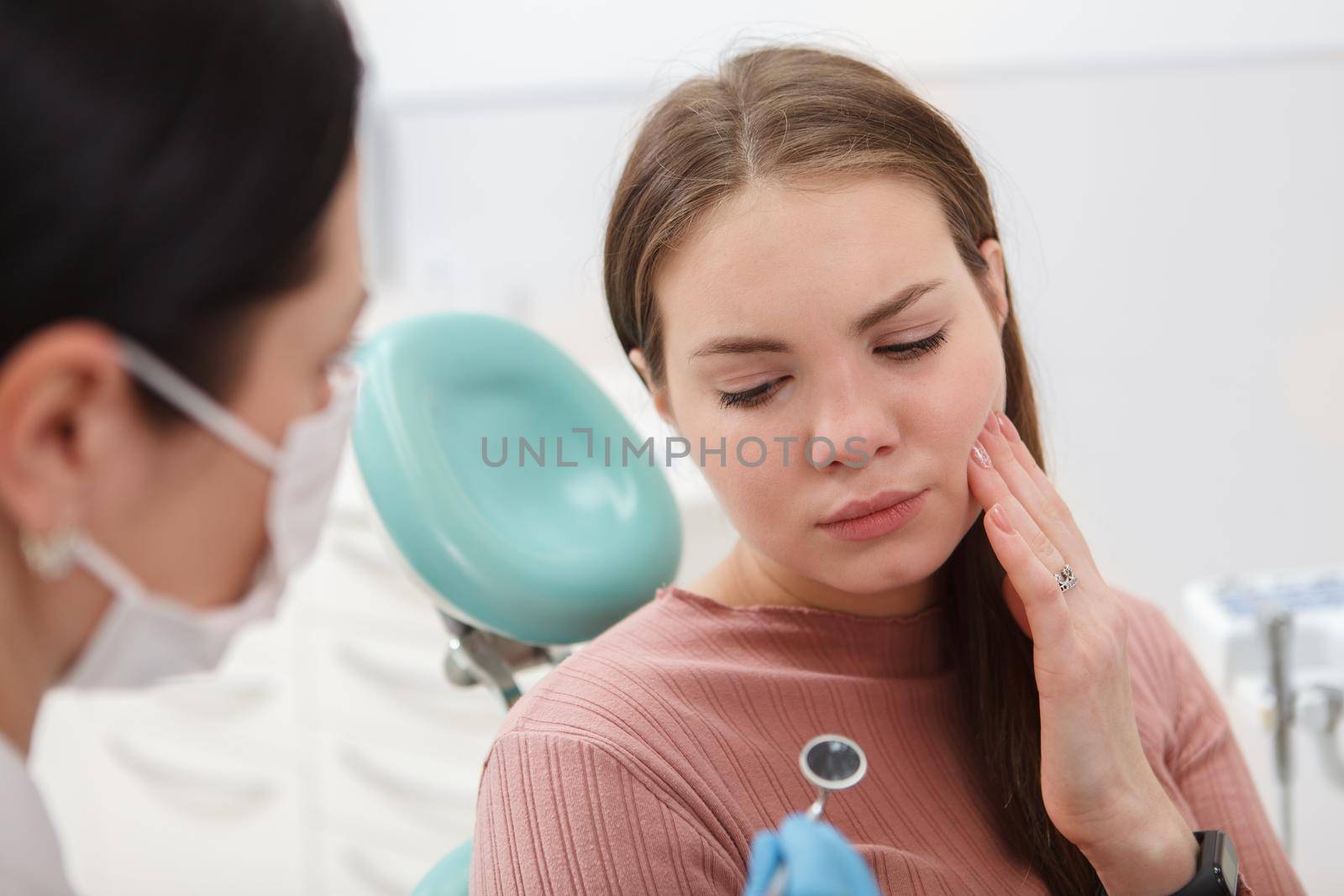 Close up of a woman with toothache having dental appointment at the clinic