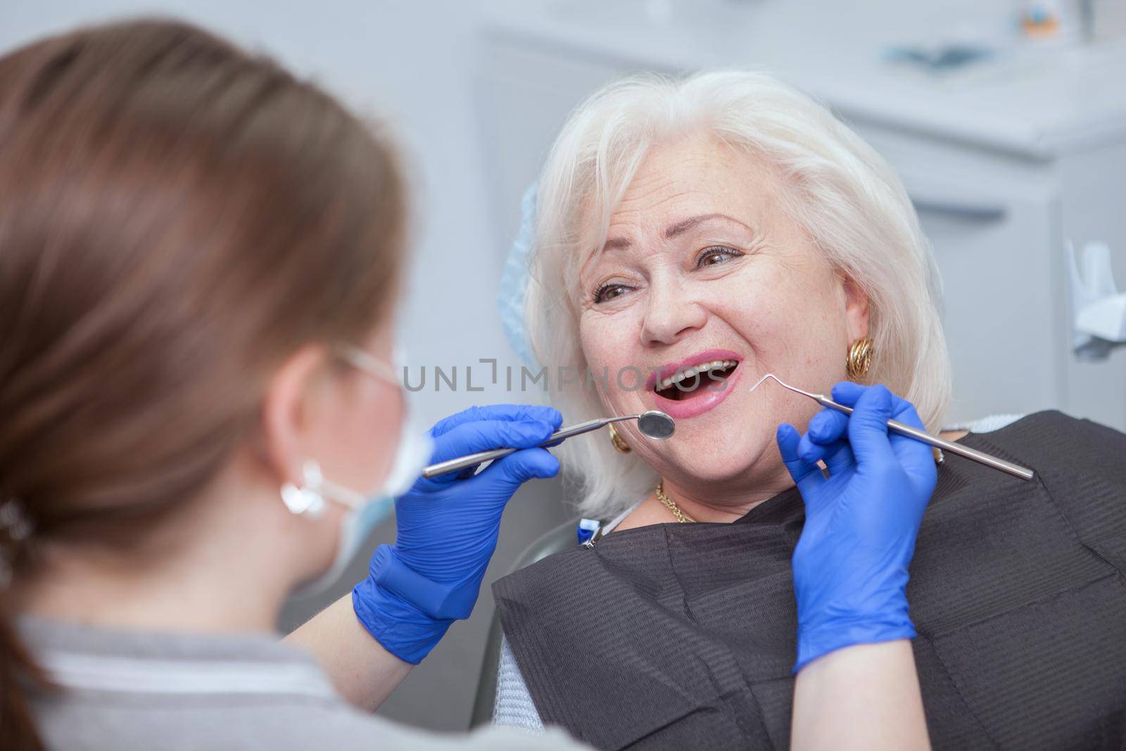 Senior woman having dental appointment by MAD_Production