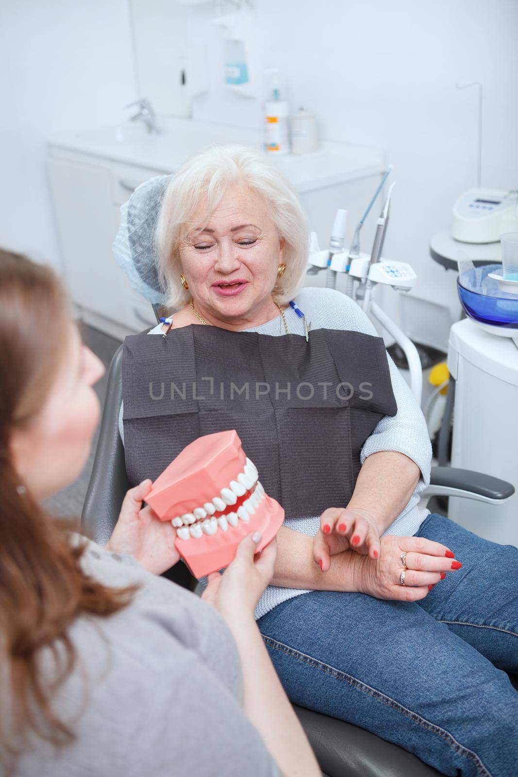 Senior woman having dental appointment by MAD_Production