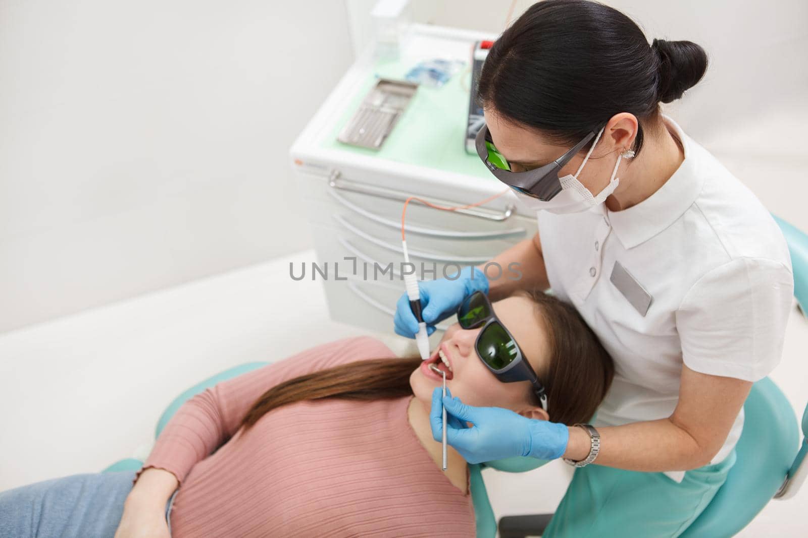 Top view shot of a professional female dentist cleaning teeth of female patient, copy space