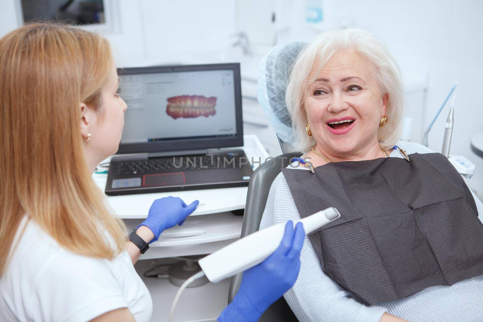 Senior female patient having dental scanning by her dentist at the clinic
