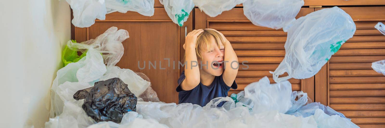 The boy's parents used too many plastic bags that they filled up the entire kitchen. Zero waste concept. The concept of World Environment Day. BANNER, LONG FORMAT