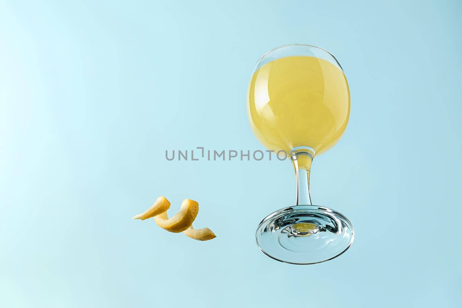 Bright summer lemon tropical cocktail in a glass for a party or picnic. Bottom view.