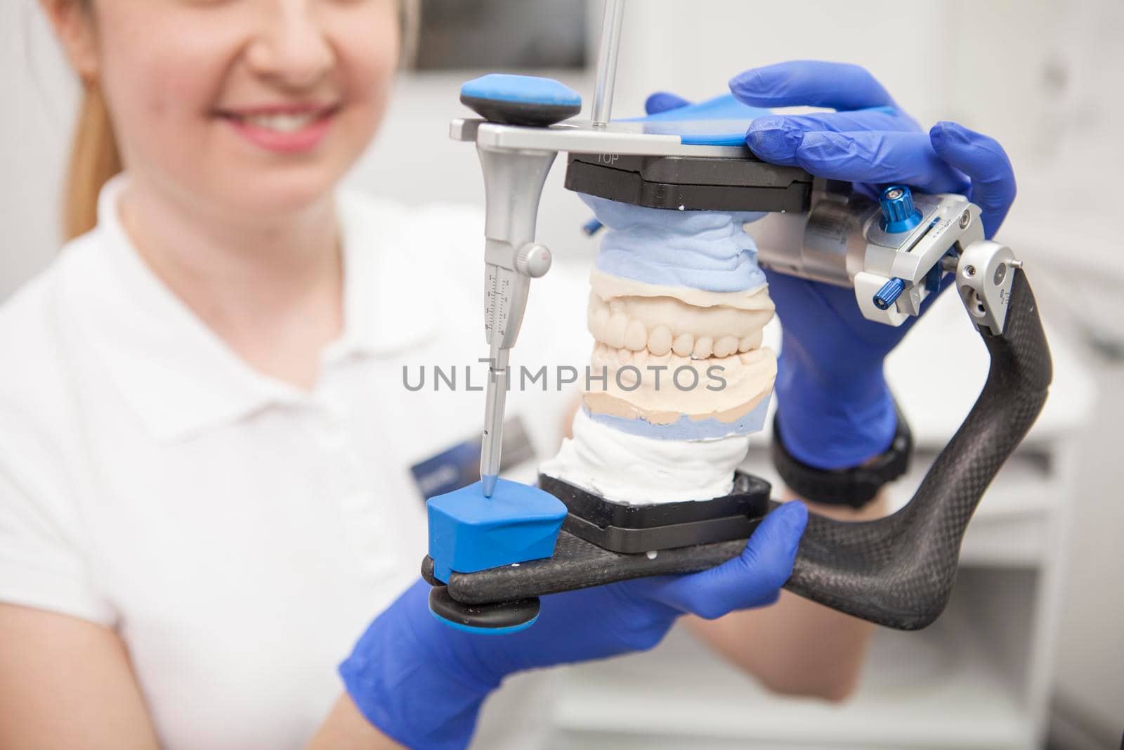 Selective focus on dental jaw mold in the hands of female dentist