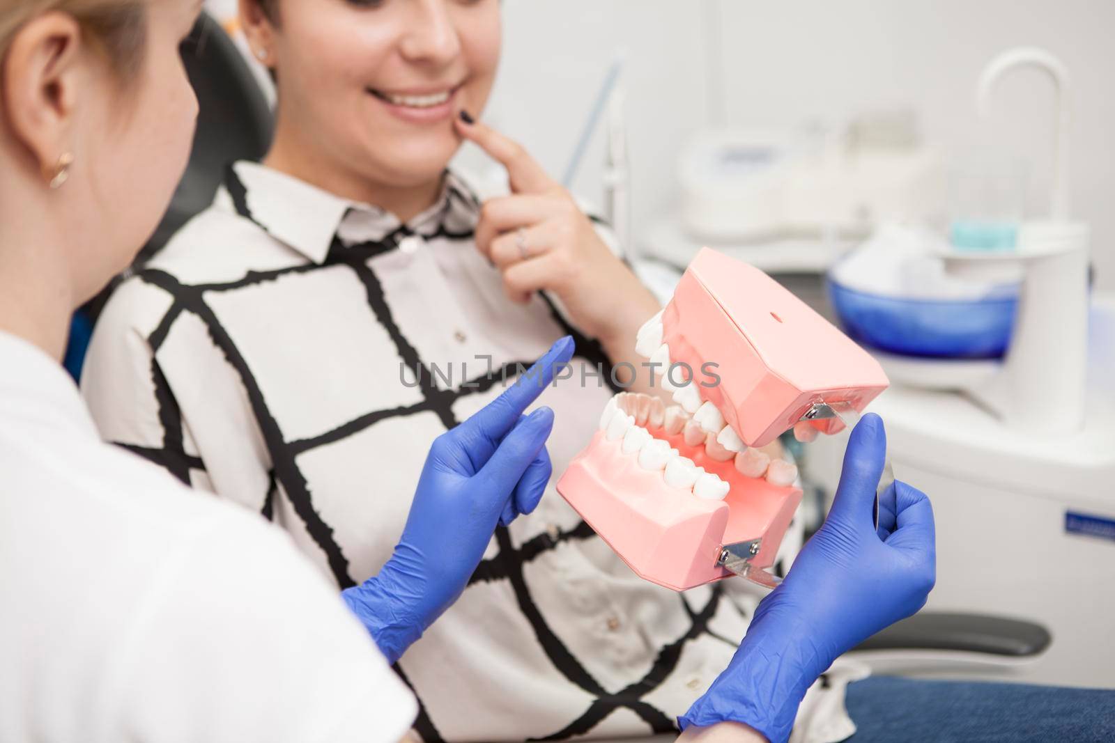Cropped shot of a dentist educating her patient about dental hygiene