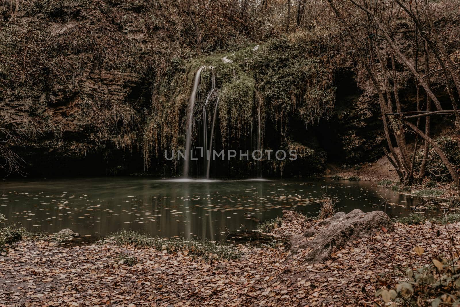 small pond lake river green. summer-autumn after sunset fallen orange leaves mist. waterfall Burbun in village Lysets Dunaivtsi Khmelnytskyi Ukraine