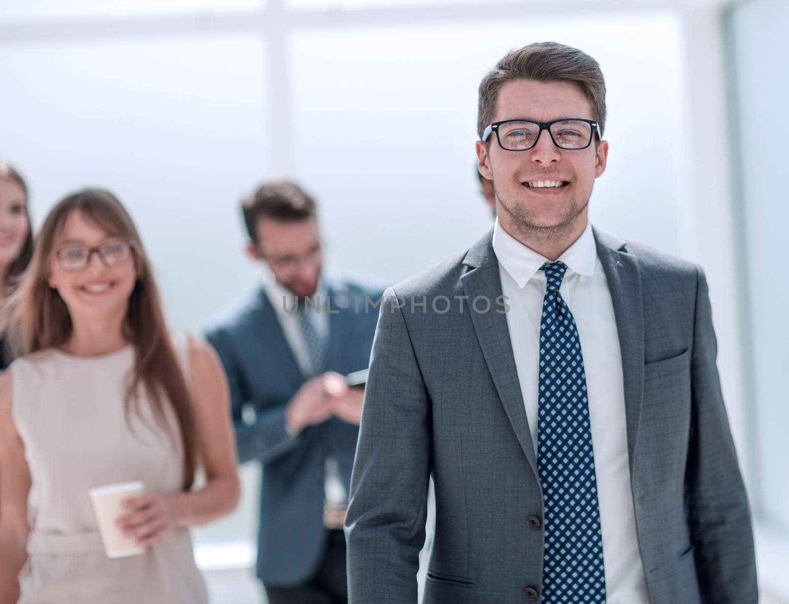 confident young businessman in the background of the office by asdf