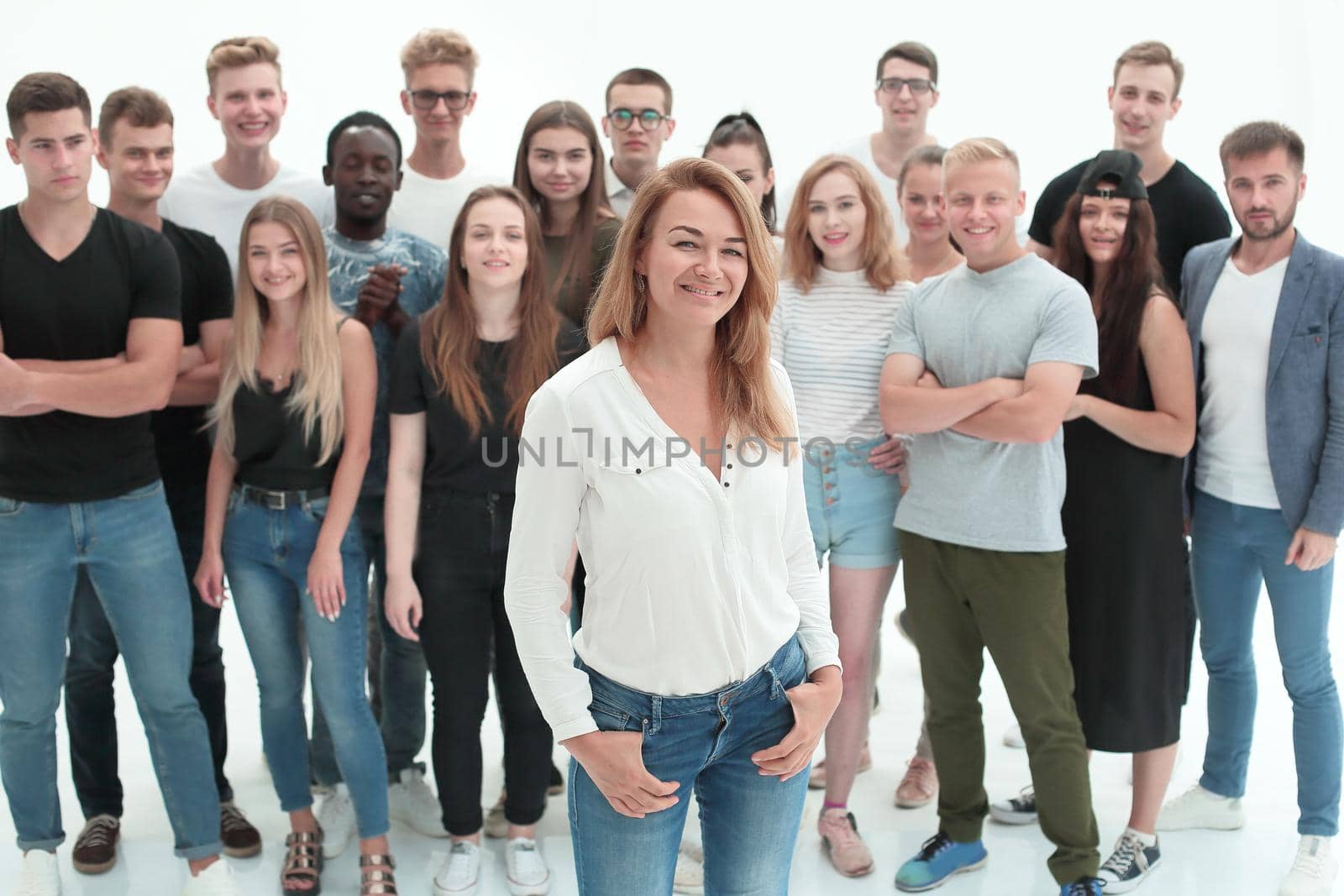 confident business woman standing in front of a young business team. isolated on white