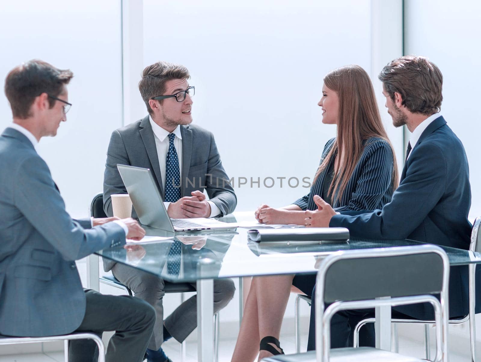 businessman discussing something with employees at a meeting by asdf