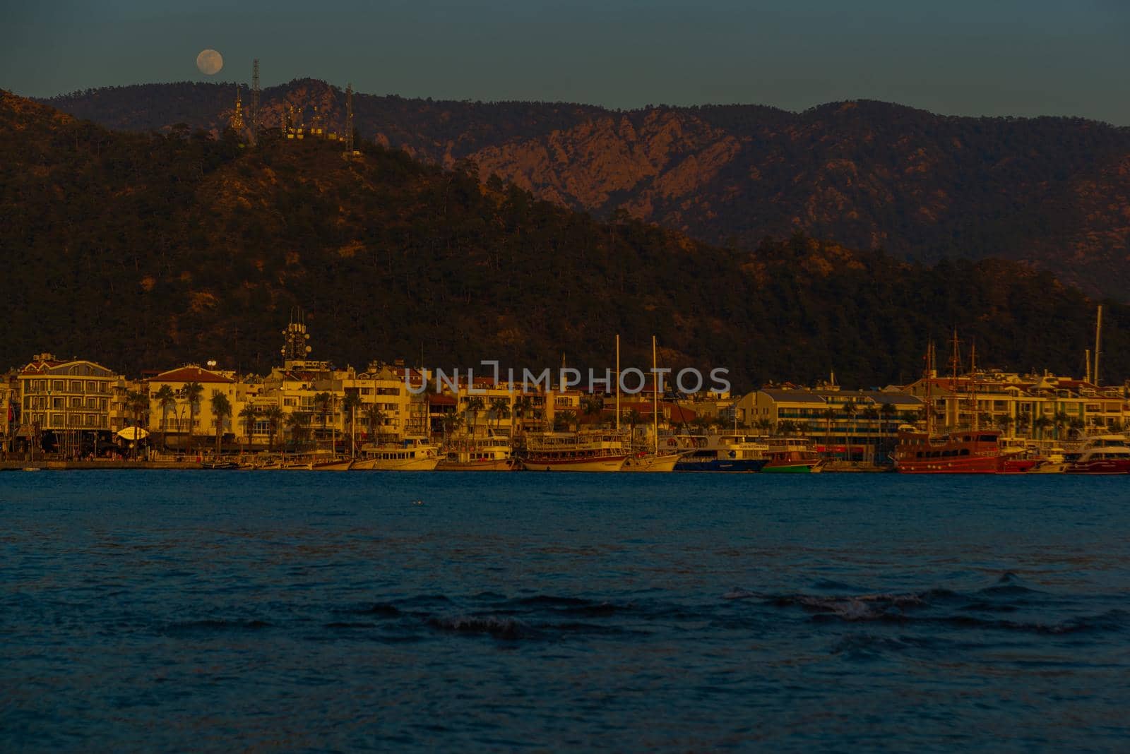 MARMARIS, MUGLA, TURKEY: Landscape with a view of the old town, Fortress and ships in Marmaris at sunset.