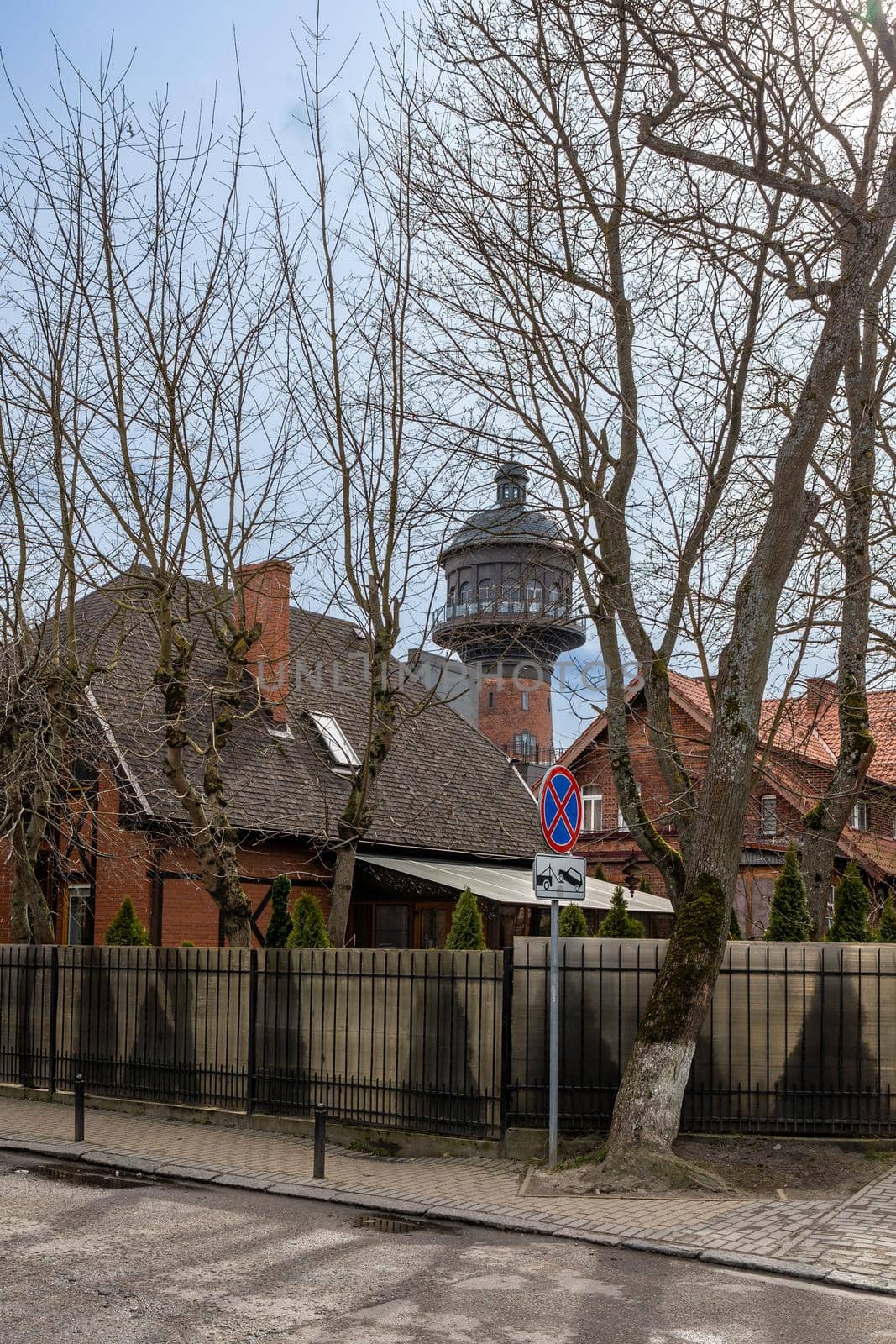 View of old European houses with tiled roofs and a high water tower in the city center in Zelenogradsk, Kaliningrad region, Russia, near the Baltic sea.