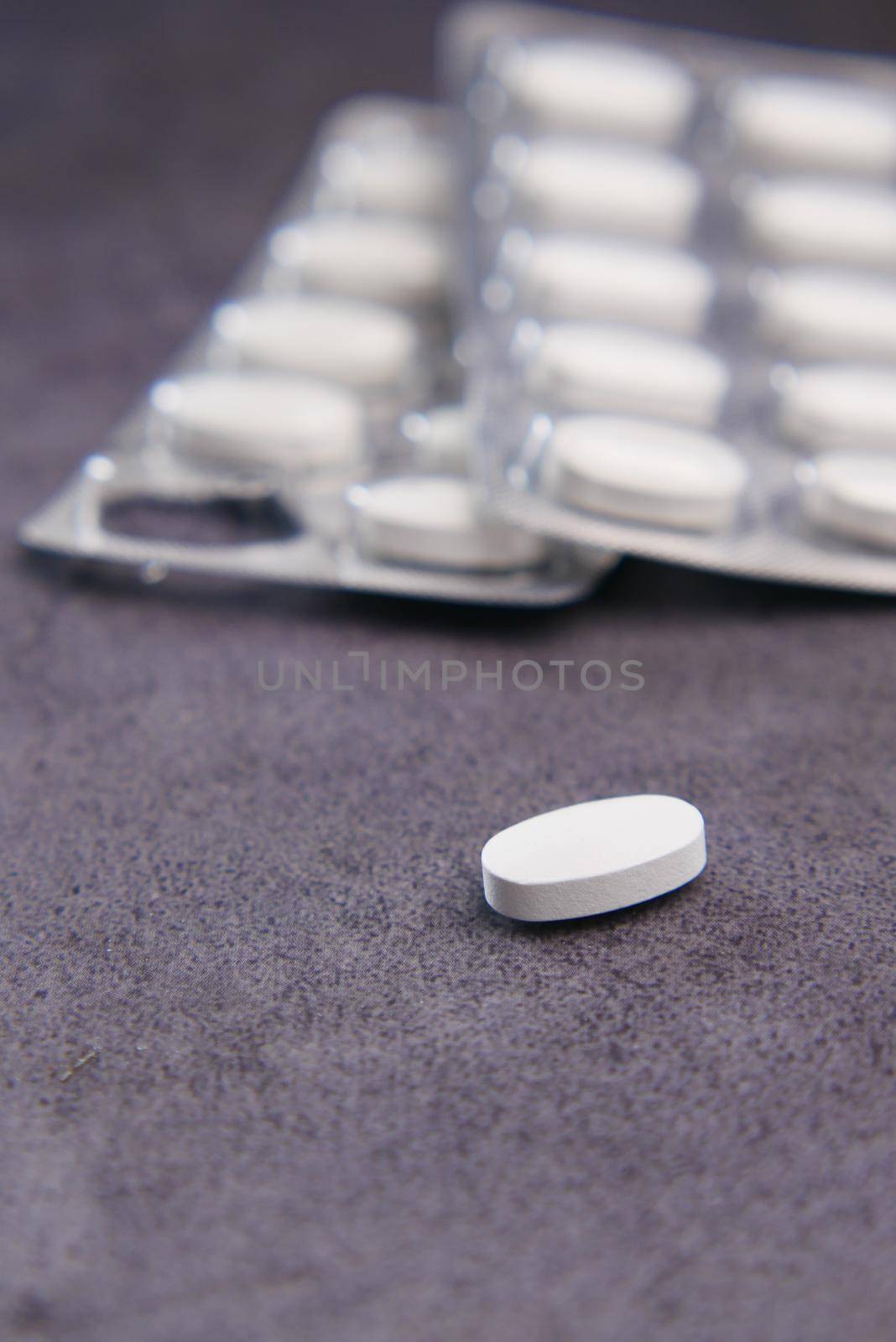 Close up of pills of blister pack on table .