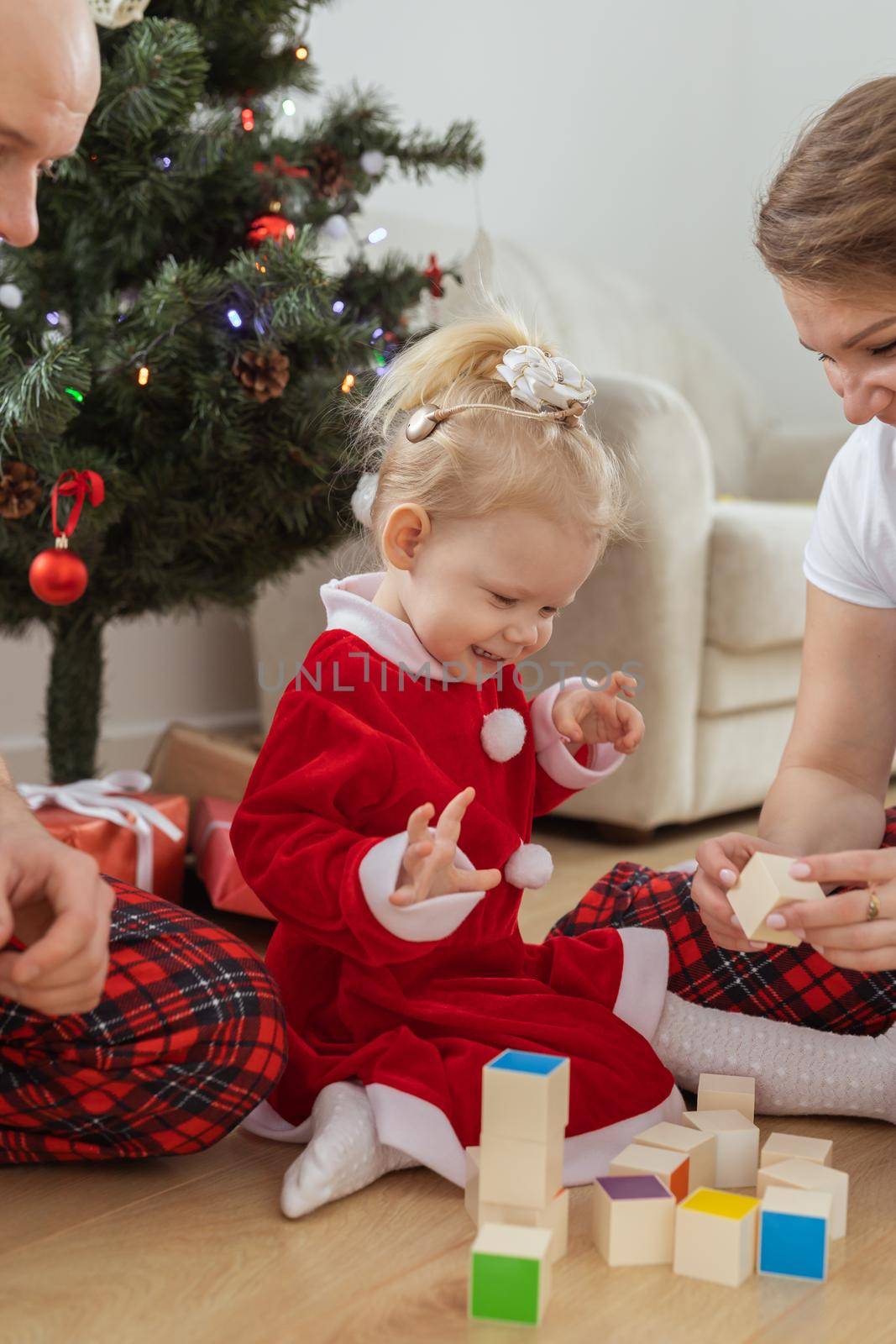 Toddler child with cochlear implant decorating christmas tree deafness and innovating medical technologies for hearing aid