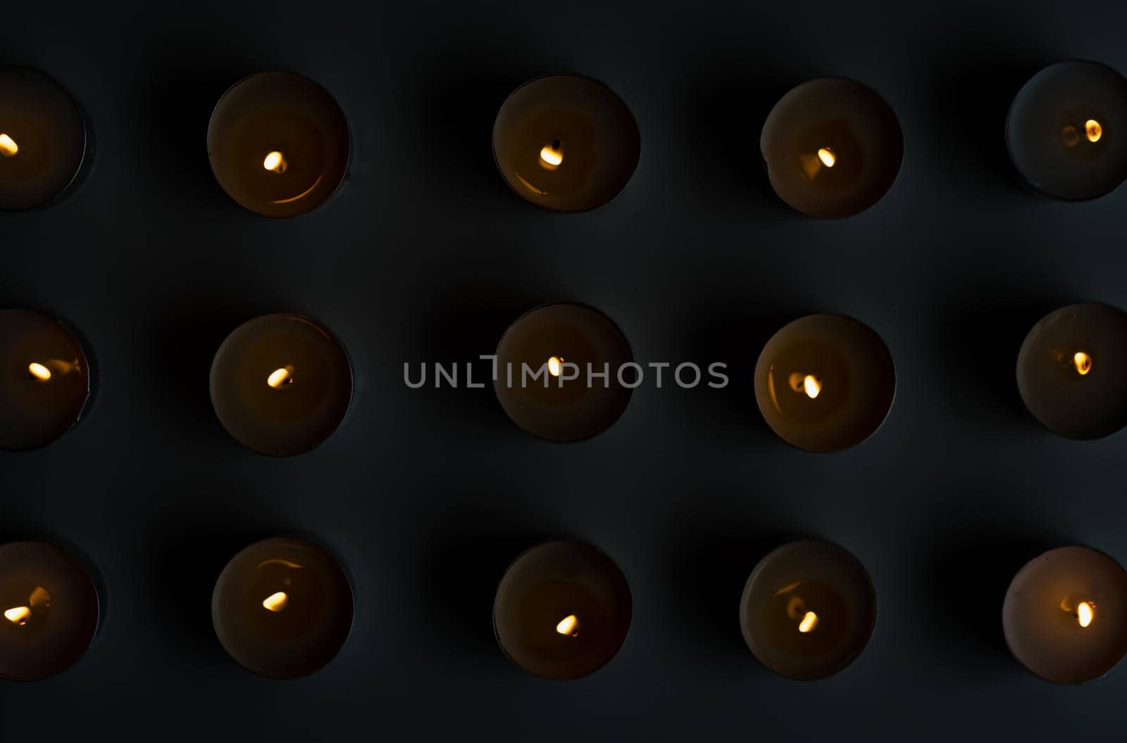 High angle view of lit tea lights arranged on table (selective focus) by natalie_board