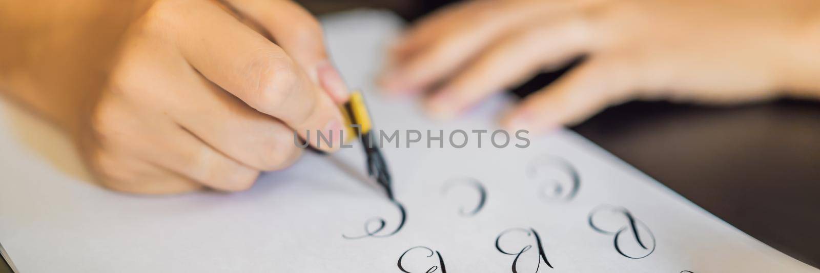 BANNER, LONG FORMAT Calligrapher Young Woman writes phrase on white paper. Inscribing ornamental decorated letters. Calligraphy, graphic design, lettering, handwriting, creation concept.