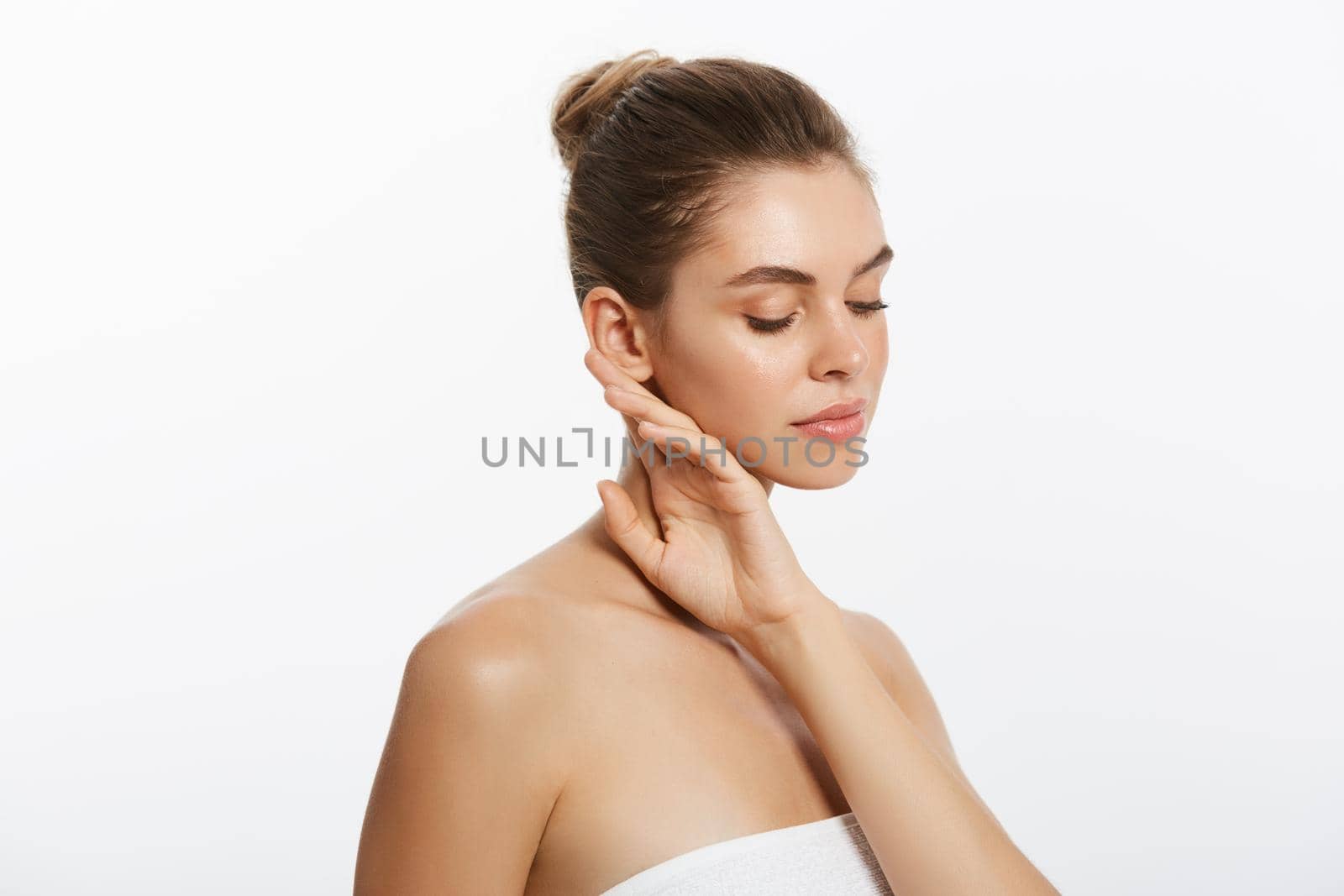 Beautiful Caucasian woman with towel against a white background. by Benzoix