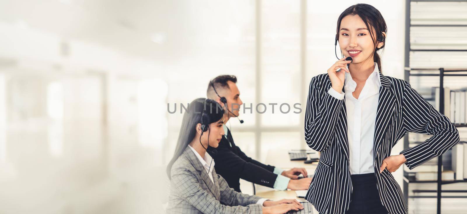 Business people wearing headset working in office broaden view by biancoblue