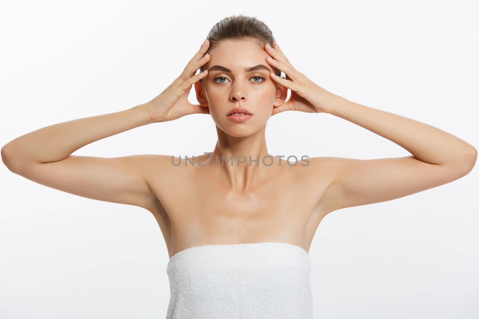 Beautiful young girl with smooth skin on a light background with natural make-up. by Benzoix