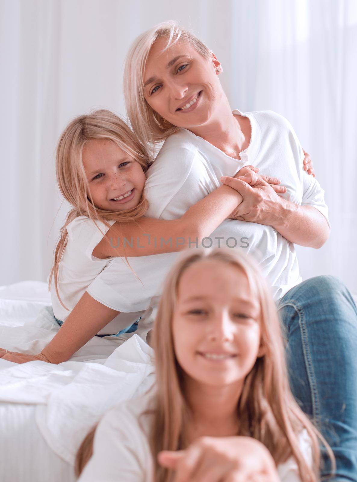 portrait of a mother with two small daughters . isolated on white background