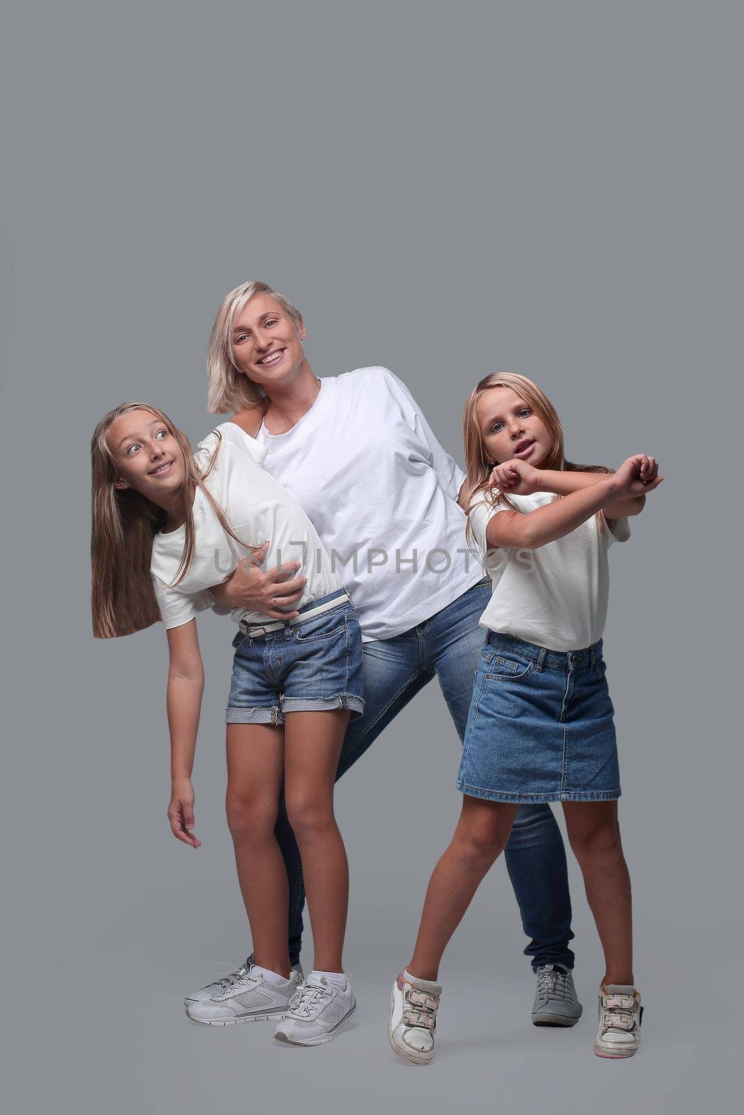 in full growth. mother and children dance together . isolated on white background