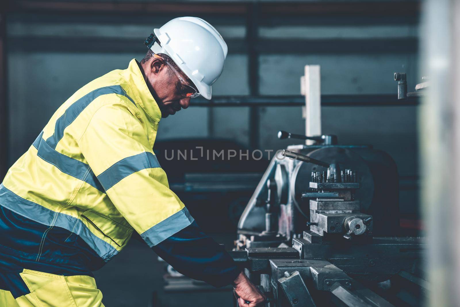 Factory worker or engineer do machine job in adept manufacturing workshop . Industrial people and manufacturing labor concept .