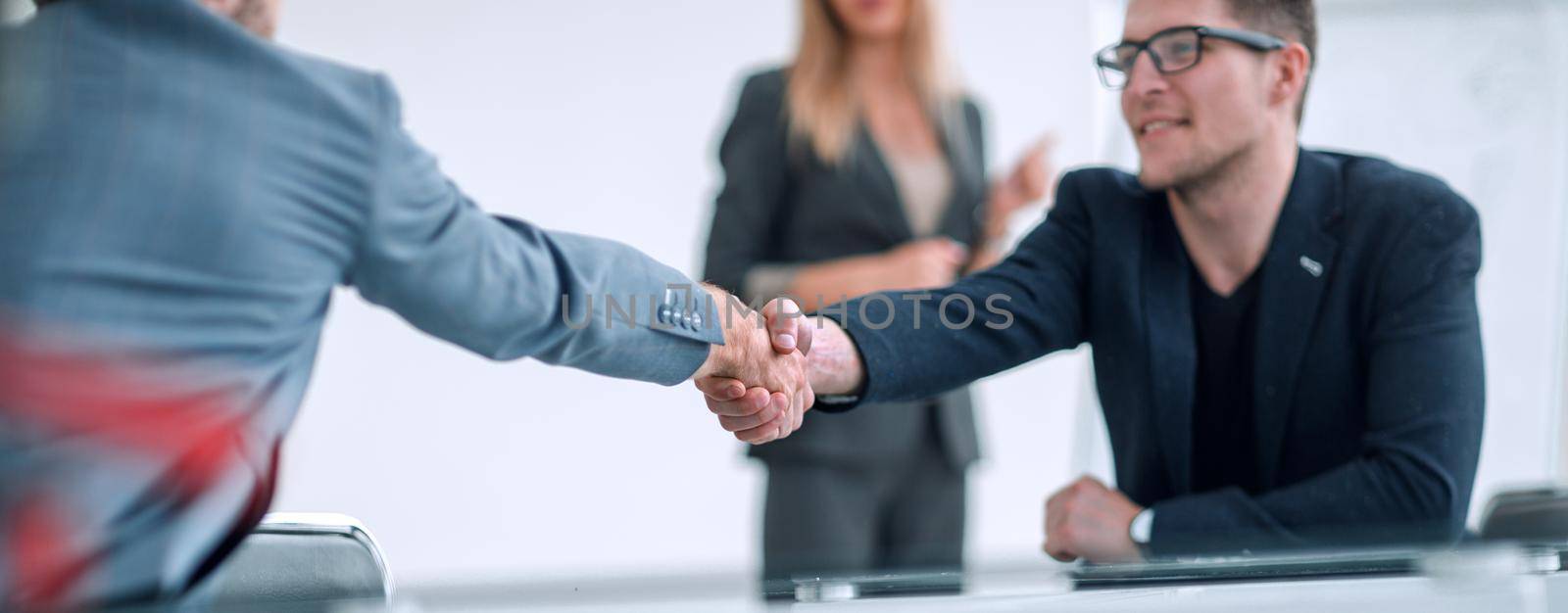 close up. business man shaking hands with his business partner. by asdf