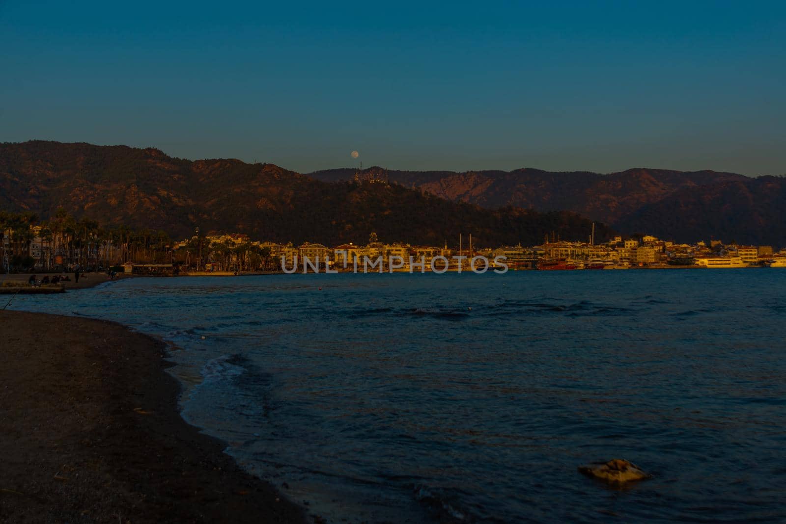 MARMARIS, MUGLA, TURKEY: Landscape with a view of the old town, Fortress and ships in Marmaris at sunset.