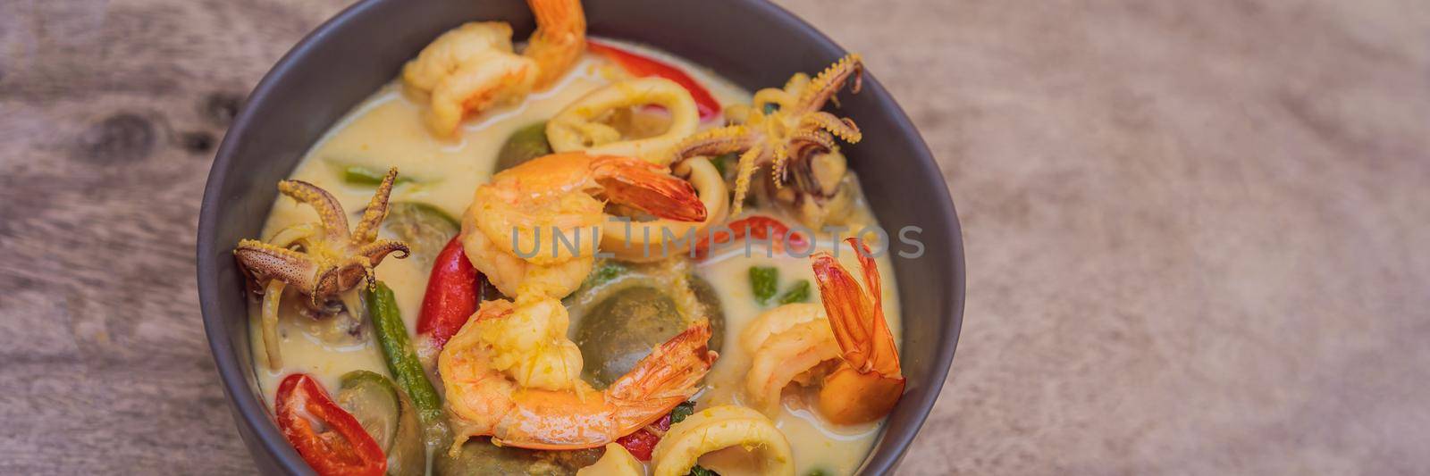 Thai food chicken green curry on dark wooden background. top view BANNER, LONG FORMAT by galitskaya